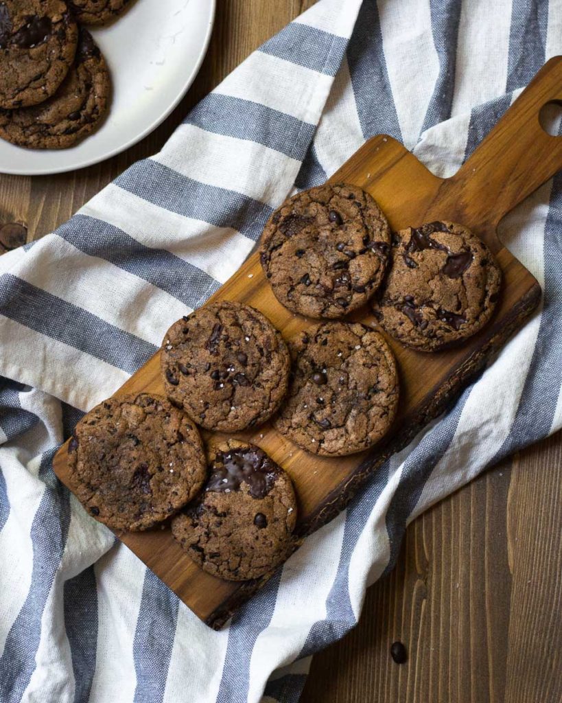 coffee cookies with chocolate chips on a wooden serving board