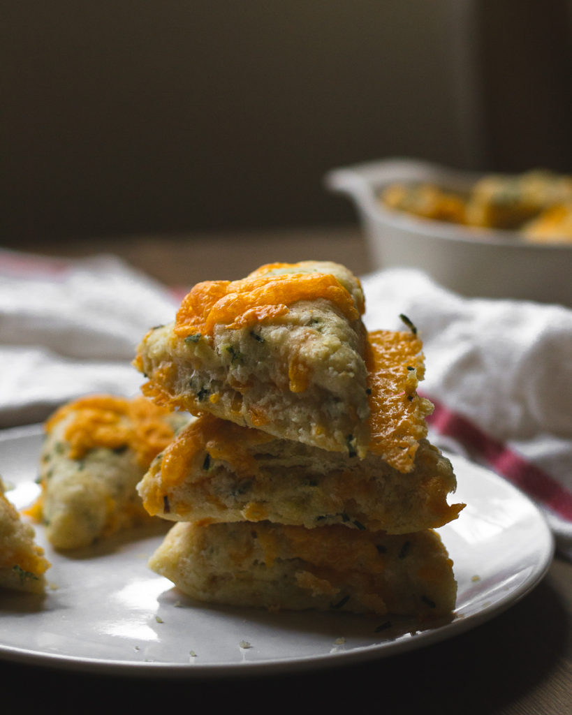 stacked cheddar scones with chives on a plate