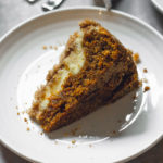 single slice of carrot coffee cake on a white plate