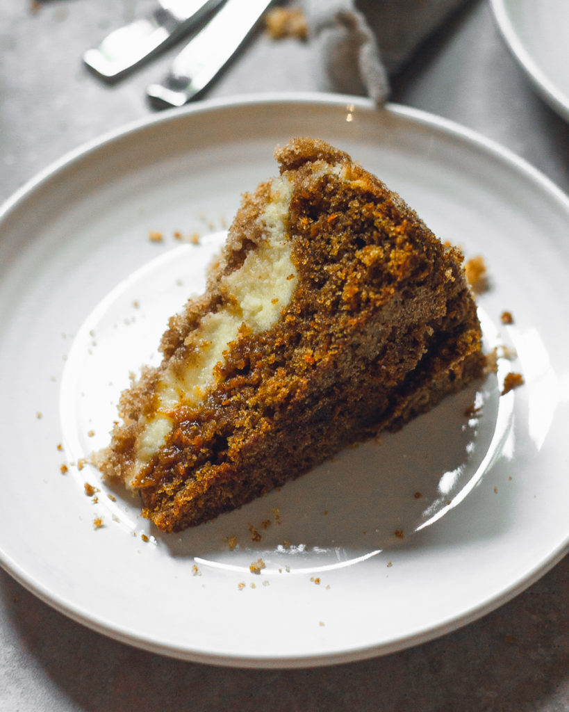 single slice of carrot coffee cake on a white plate