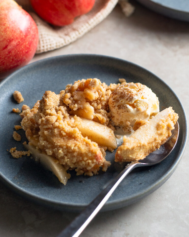 Warm and cozy dutch apple crisp with vanilla ice cream and cinnamon, ready for fall.