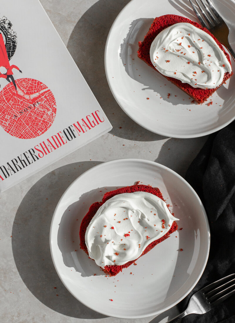 red velvet loaf cake shown next to a darker shade of magic by v.e. schwab