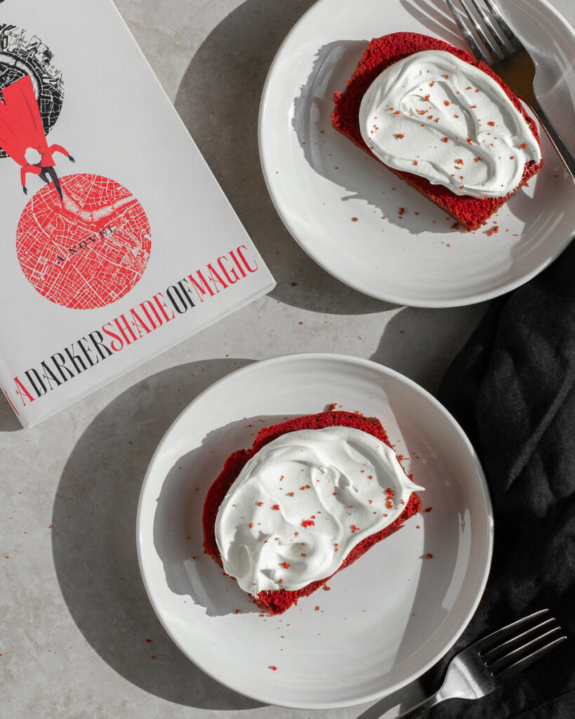 red velvet loaf cake shown next to a darker shade of magic by v.e. schwab