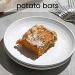 A slice of swirled marshmallow sweet potato bar on a white plate. Text reads "swirled marshmallow sweet potato bars" and "ficklebeabakehouse.com"