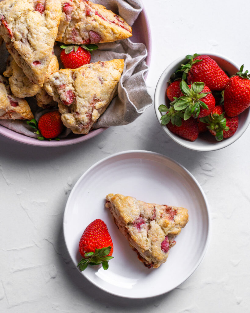 Flaky tender strawberry scones baked to golden brown perfection and ready to be served at brunch.