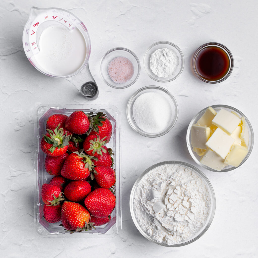 Ingredients that have been measured and are ready to be used in a roasted strawberry scone recipe.