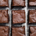 Basic fudgy homemade brownies cooling on a wire rack and ready to be enjoyed!