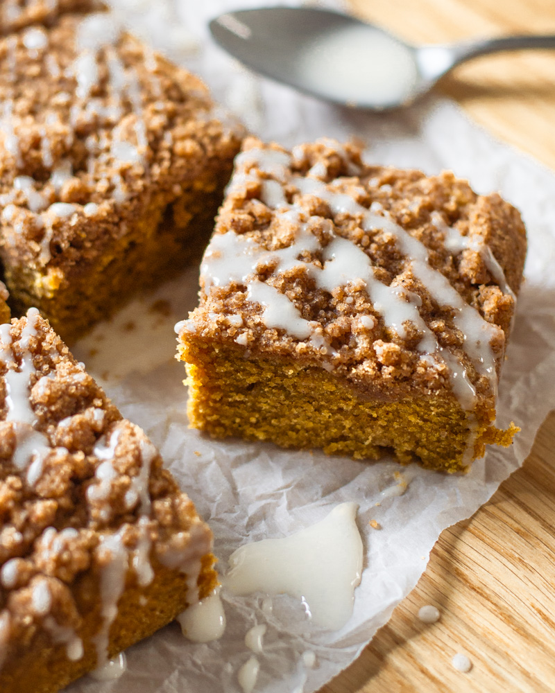 A slice of pumpkin spice coffee cake, ready to be enjoyed with your morning cup of coffee!