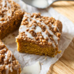 A slice of pumpkin spice coffee cake, ready to be enjoyed with your morning cup of coffee!