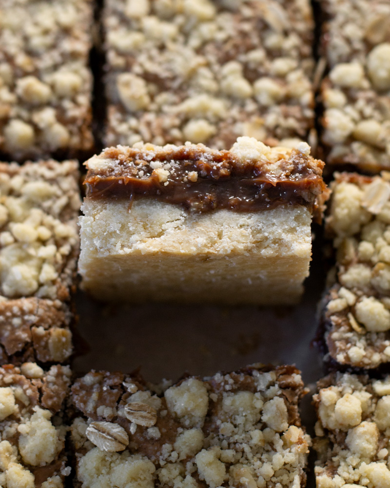 The perfect shortbread cookie crust topped with creamy sweet Nutella custard and and oat cookie crumbles.