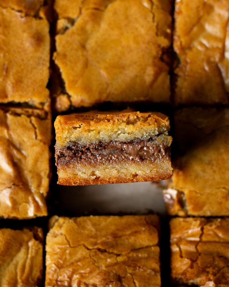 Golden brown malted Nutella blondies with gooey Nutella filling.