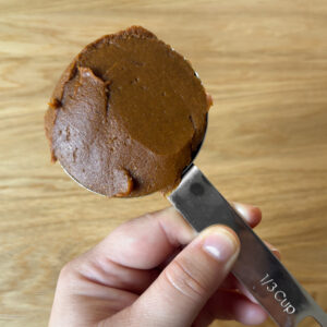100% pumpkin puree and pumpkin pie spice blend after getting cooked down on the stove, portioned out in a 1/3 cup measuring spoon.