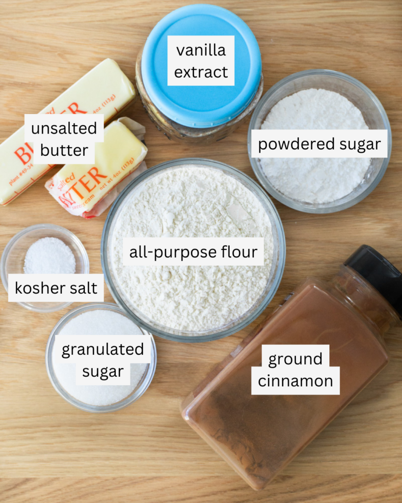 Labeled ingredients for broiled cinnamon shortbreads: unsalted butter, vanilla extract, powdered sugar, all-purpose flour, kosher salt, granulated sugar, ground cinnamon.