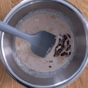 Halfway through combining the steamed milk, semi-sweet chocolate chips, and kosher salt.