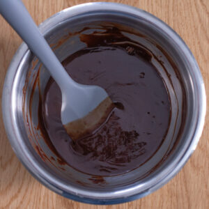 Warm semi-sweet chocolate ganache, ready to be used as a thumbprint cookie filling.