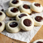 An easy recipe for delicious semi-sweet chocolate ganache vanilla thumbprint cookies that go great with a cold glass of milk!